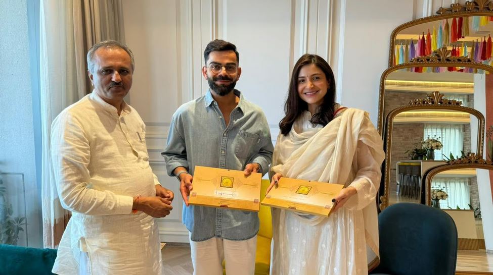 Virat Kohli and Anushka Sharma with the Ram Mandir invite | X