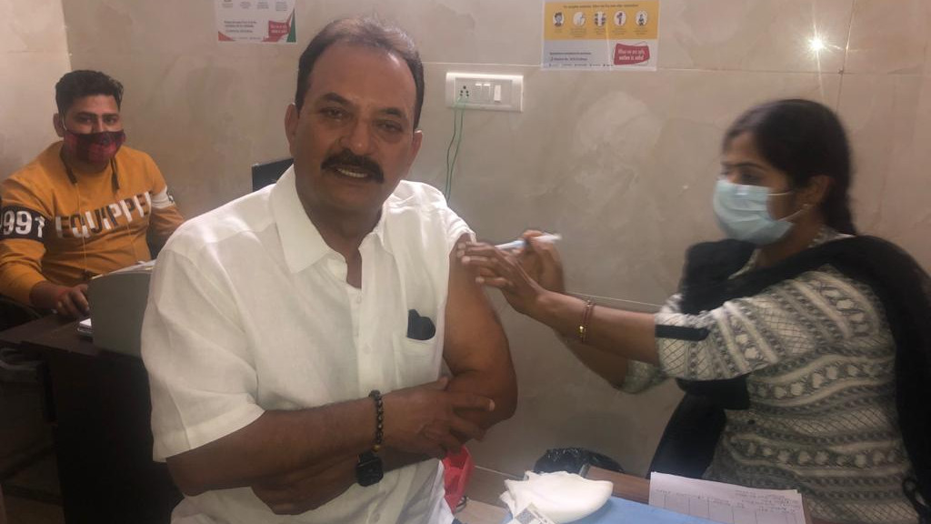 Madan Lal receives his first dose of COVID-19 vaccine in Delhi