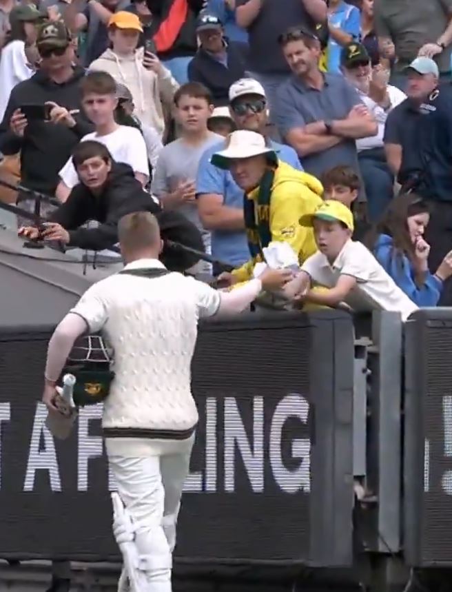 Warner handed his gloves to a young fan as he walked out of MCG | X