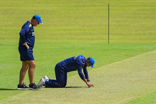 Dimuth Karunaratne and Mickey Arthur inspect the pitch in Kandy | Getty Images
