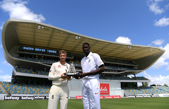 Joe Root and Jason Holder pose with the Wisden Trophy at Kensington Oval | Getty Images
