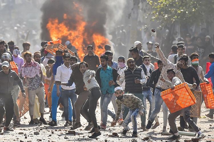 Rioters throwing stones and objects at police and paramilitary forces