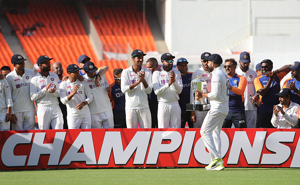 Virat Kohli handing over the trophy to his 'Champions' | Getty