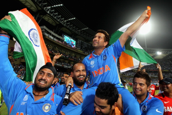 Sachin Tendulkar on shoulders on his teammates with the tricolor in hand | Getty