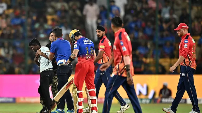Fan taken off the field after he hugged Virat Kohli and touched his feet | IPL-BCCI