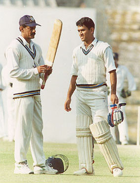 MS Dhoni getting his bat checked by Bengal's Utpal Chatterjee