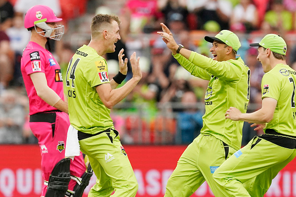 Morris celebrates the wicket of Hughes with Sydney Thunder teammate | Getty Images