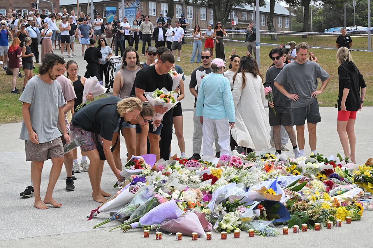 Mourners place flowers at a makeshift memorial at Bondi Beach on Monday | AAP