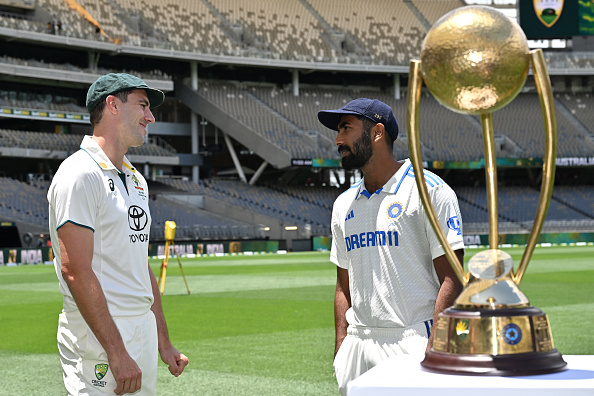 Pat Cummins with Jasprit Bumrah and BGT trophy | Getty