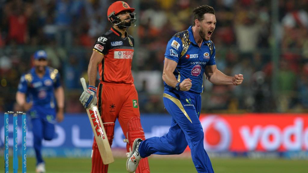 Mitchell McClenaghan exults after taking the wicket of Virat Kohli | AFP