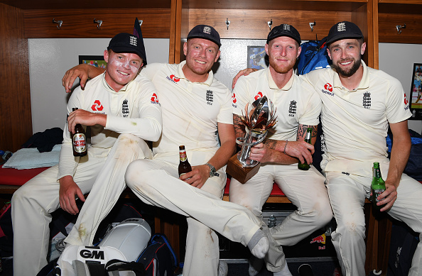 Chris Woakes (R) with his England teammates | Getty