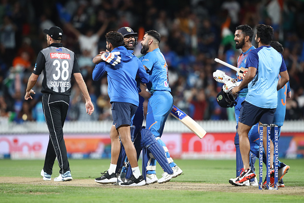 Rohit Sharma engulfed by his teammates after the win | Getty