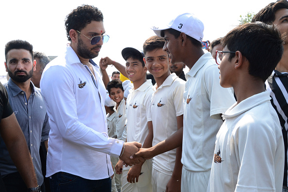 Yuvraj shakes hands with youths during the opening of the Yuvraj Singh Center of Excellence | Getty