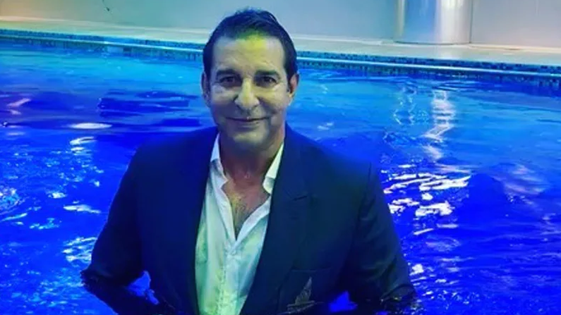 WATCH- Wasim Akram hits back at critics; enters swimming pool wearing a 3-piece suit