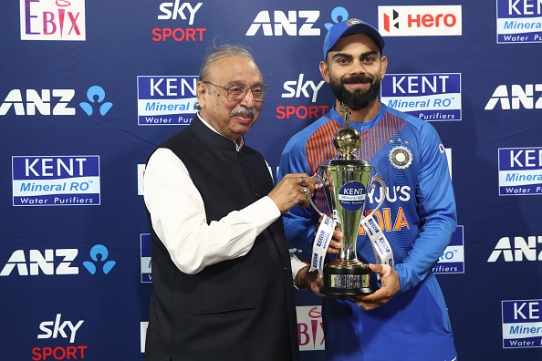 Virat Kohli (R) with the T20I series trophy | Getty