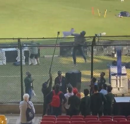 Brendon McCullum scales a fence to retrieve a shirt he had autographed for a fan | Twitter