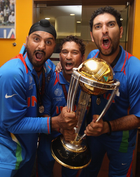 Yuvraj Singh and Harbhajan Singh with Sachin Tendulkar and the World Cup trophy | Getty