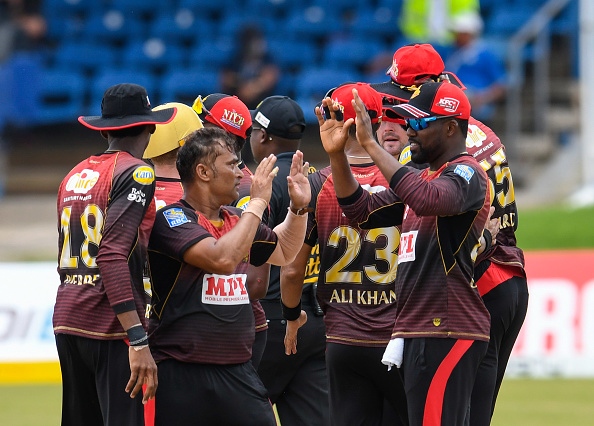 Pravin Tambe celebrates his maiden CPL wicket with teammates | Getty
