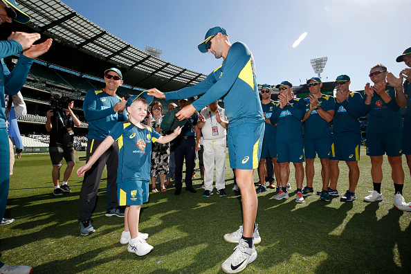 Archie Schiller is presented with his baggy green cap by Nathan Lyon | Getty