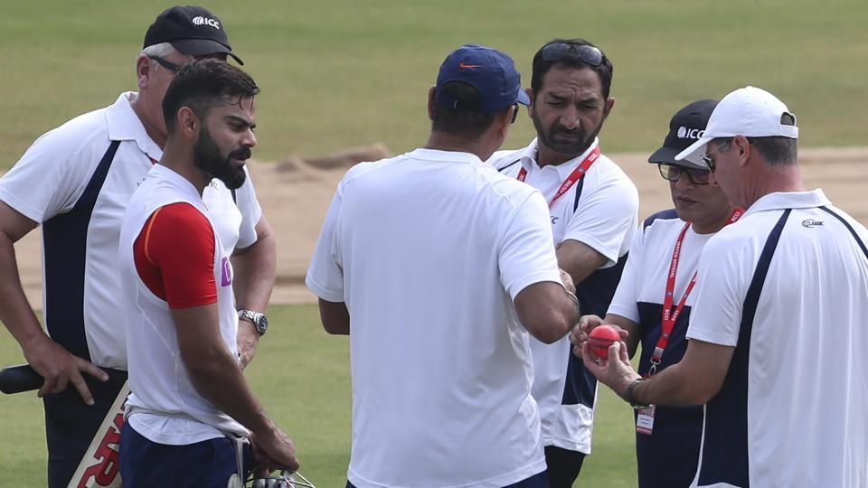 Virat Kohli looks at Pink ball as Umpires check out the new ball | AFP