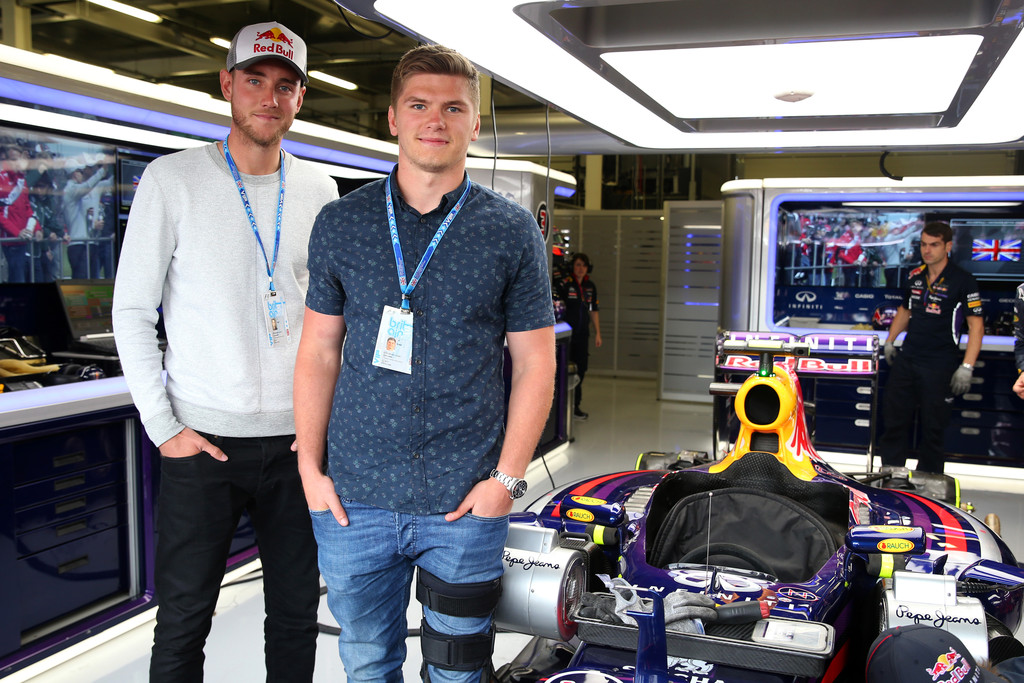 Stuart Broad and rugby player Owen Farrell in the Infiniti Red Bull Racing garage before the British Formula One Grand Prix, 2014