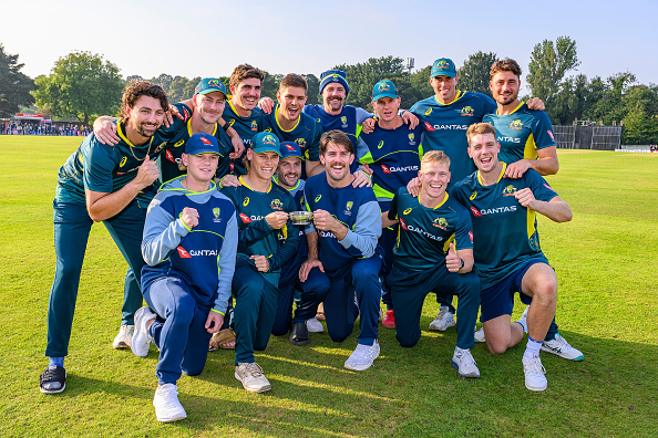 Australian players posing with the unusual trophy | Getty