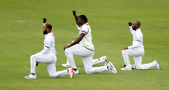 Jason Holder and his teammates taking a knee ahead of the start of first Test against England | Getty