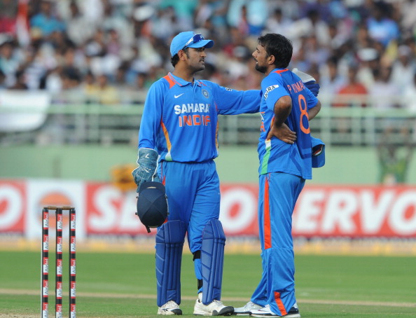 MS Dhoni and Praveen Kumar | Getty Images