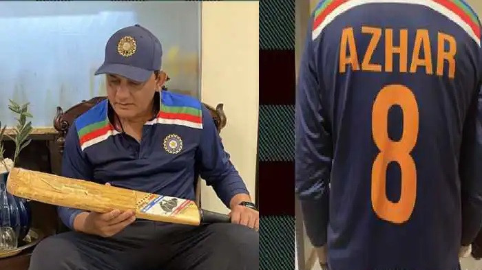 Mohammad Azharuddin shows the bat with which he scored three tons in his first three Tests