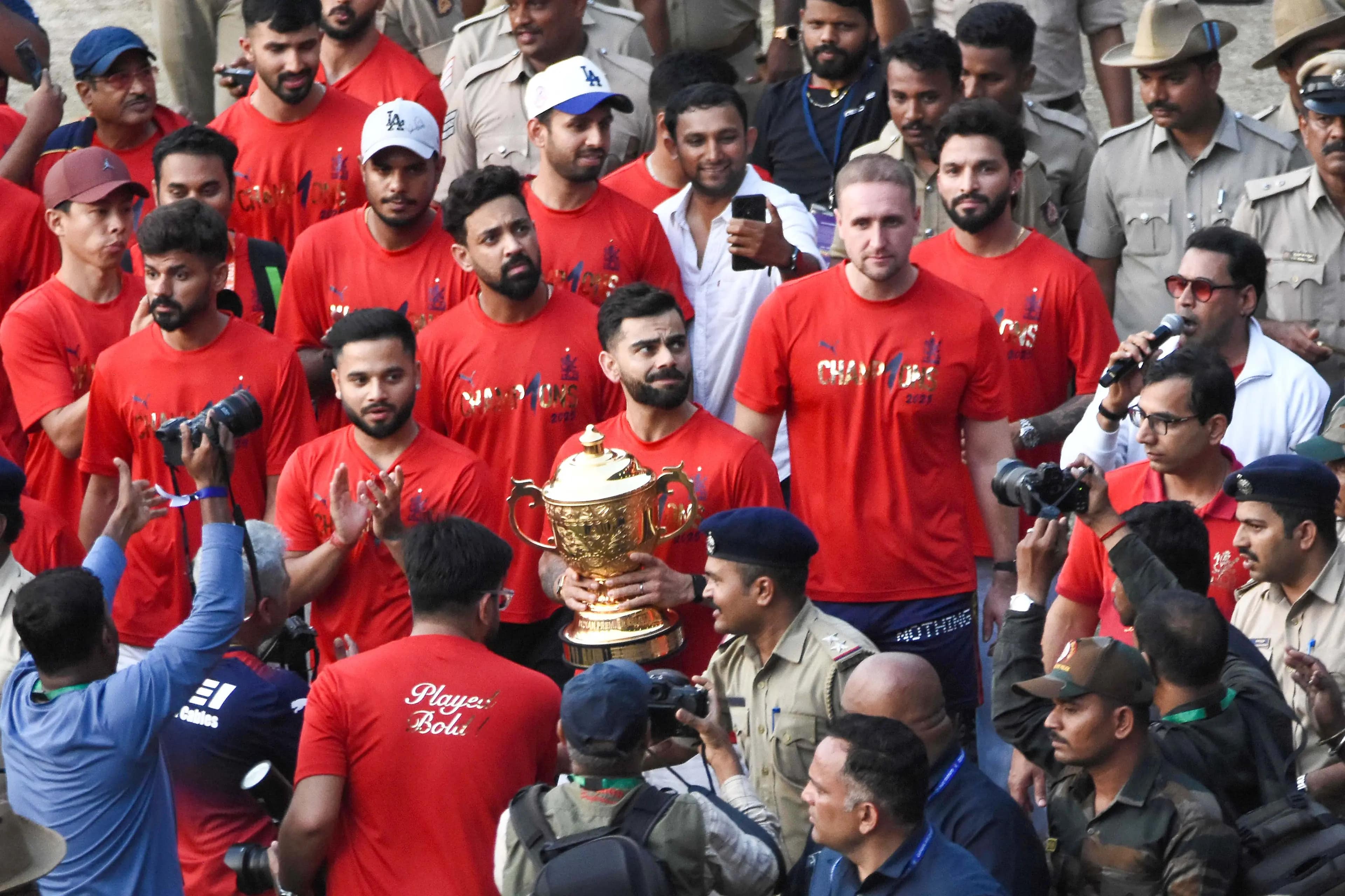 Virat Kohli holds the IPL trophy as RCB team celebrates in Chinnaswamy Stadium | RCB X