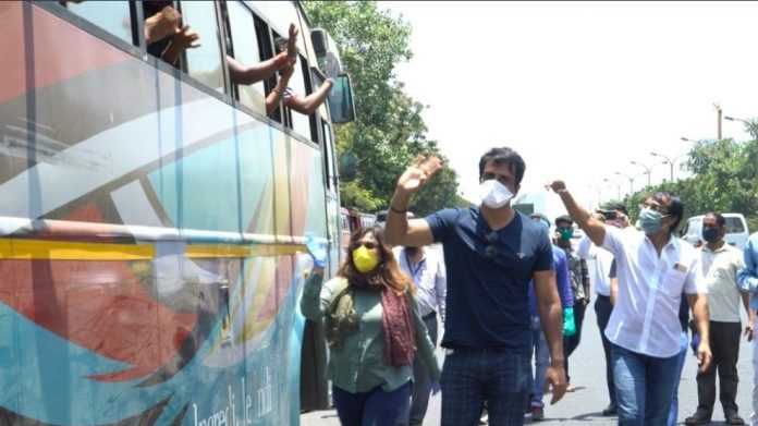 Sonu Sood flagging off a bus filled with migrant workers