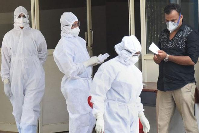 Health official and doctors covered in PPE kits 