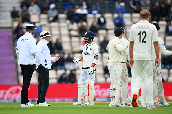 Virat Kohli having a discussion with on-field umpires | Getty