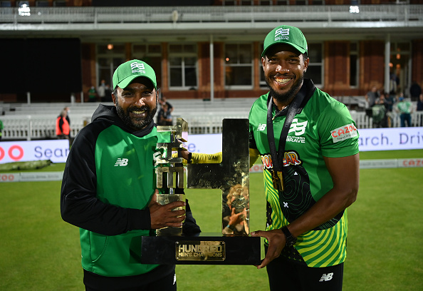 Southern Brave coach Mahela Jayawardena poses with The Hundred trophy with Chris Jordan | Getty Images