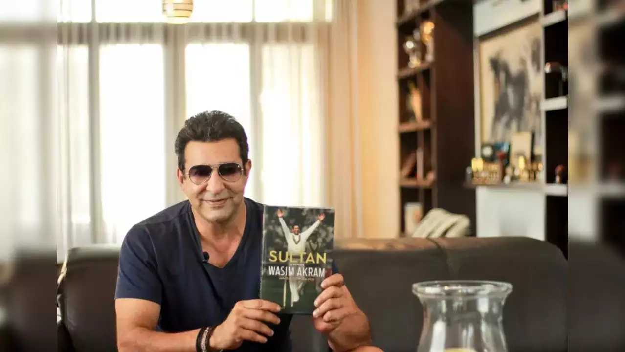 Wasim Akram with his autobiography- Sultan- A memoir | Twitter