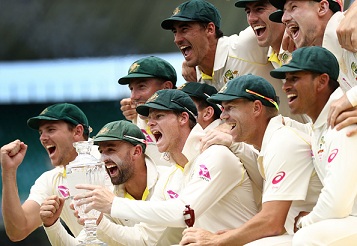 Australian team celebrating on the podium with the Ashes Trophy | Getty