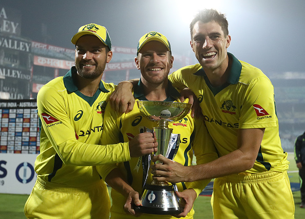 Alex Carey, Aaron Finch and Pat Cummins pose with the ODI Trophy after beating India | Getty