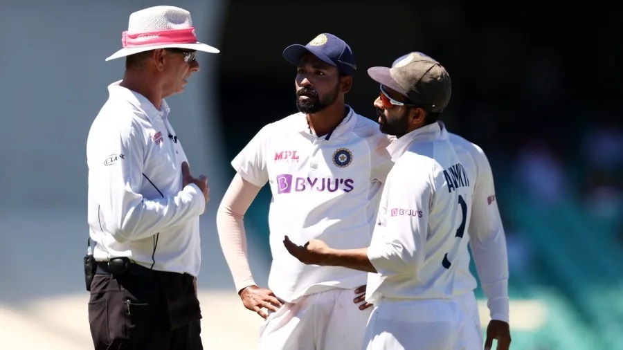 Mohammed Siraj looks on as captain Ajinkya Rahane talks to umpire over abuse from crowd | Getty