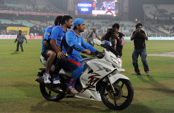 MS Dhoni on a bike with his teammates | Getty