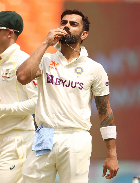 Virat Kohli kisses the necklace after reaching his 28th Test century | Getty