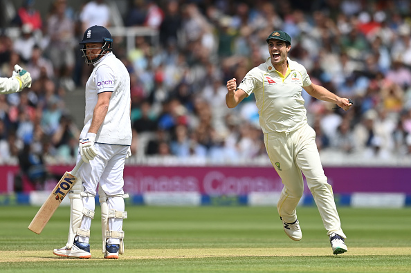 Cummins celebrates as a baffled Bairstow looks on | Getty